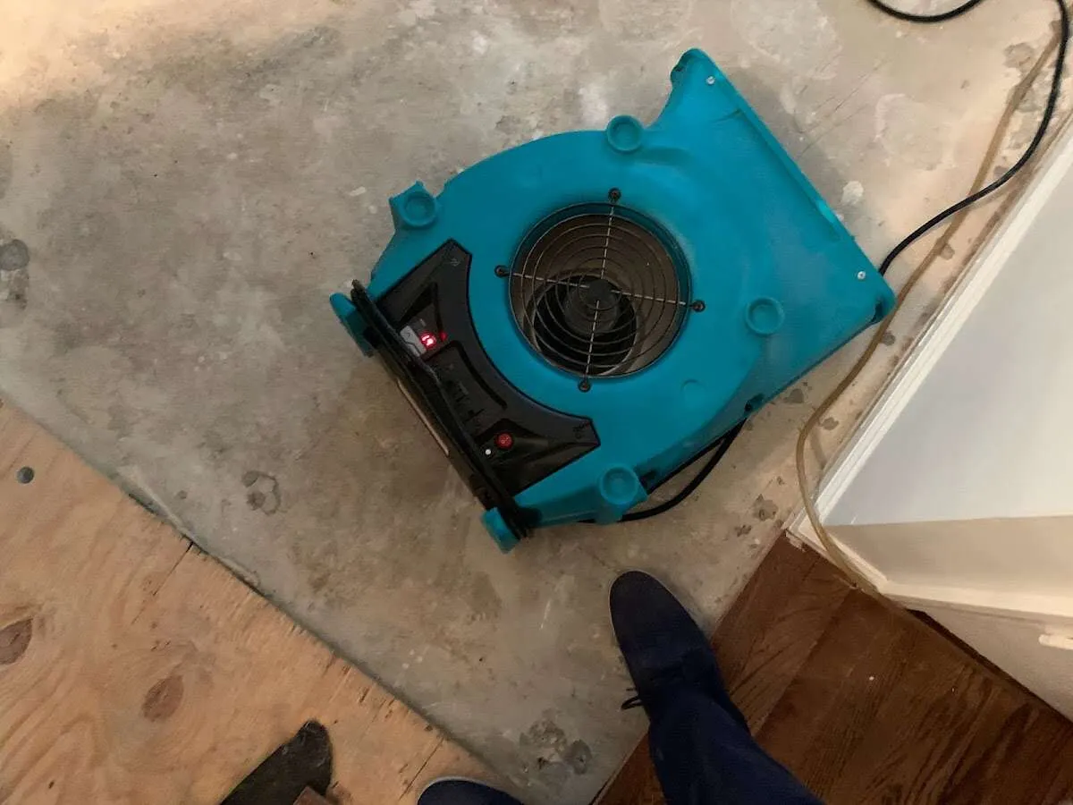 Air mover drying subfloor during Leak Detection & Repair in Lower Saucon